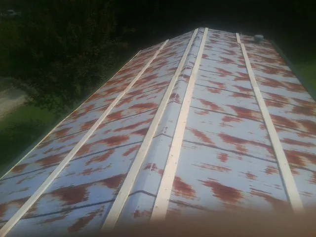 Rusted metal roof panels with new wood purlins before replacement — Storm Damage Roof Repair in Phelps by Roofing Brothers